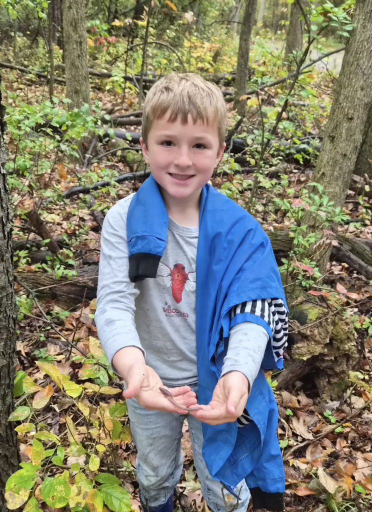 Student holding a bug