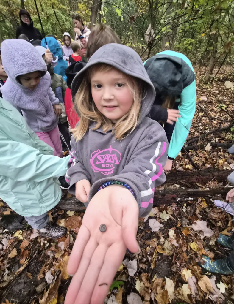 Student holding a bug