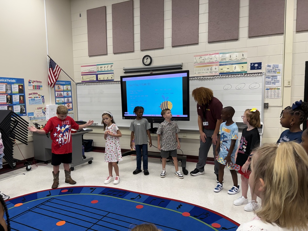 Mr. Moses, PHESA Music Teacher, playing a rhythm name game with second graders. 