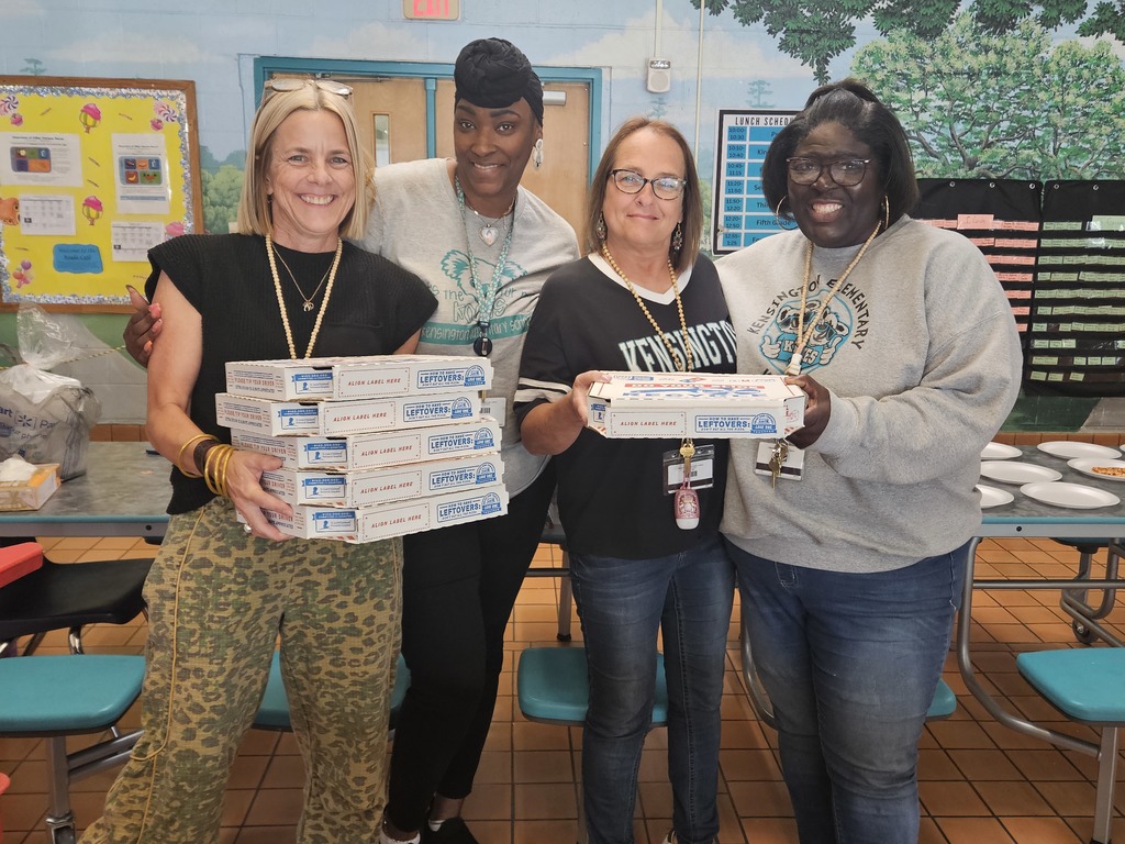 Staff members with pizza