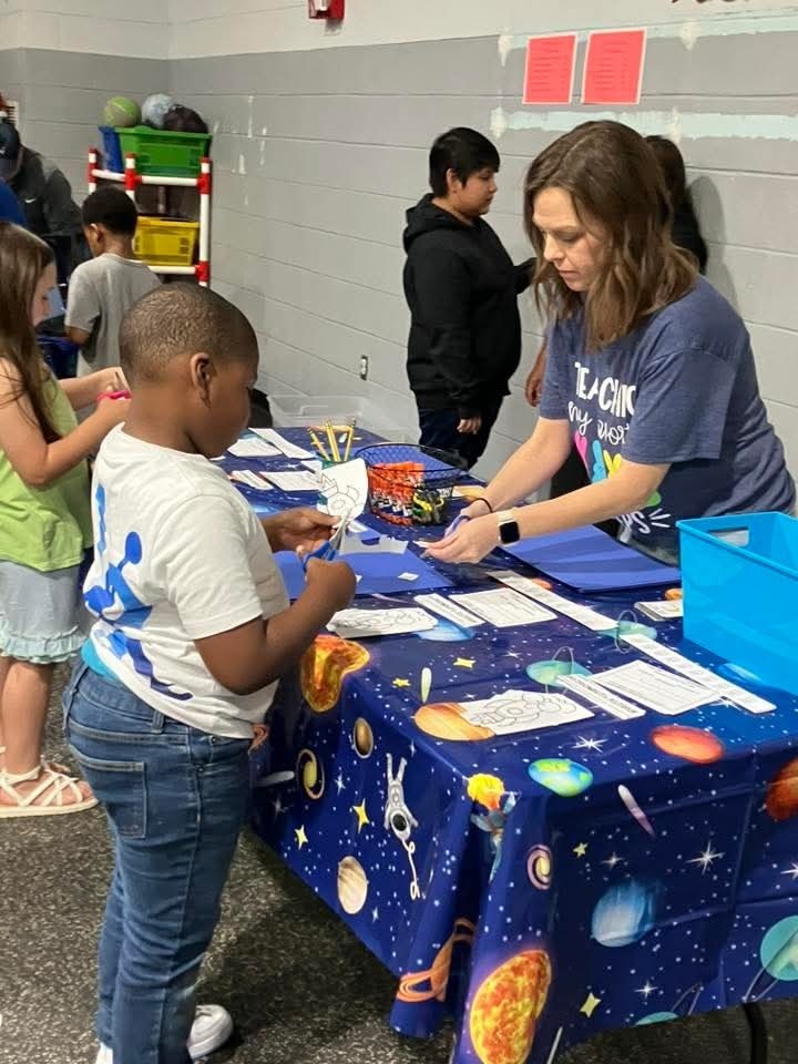 Teacher helping student with a game