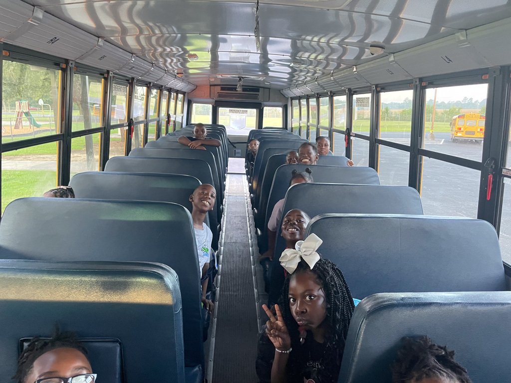 First Day oif School - students smiling on bus
