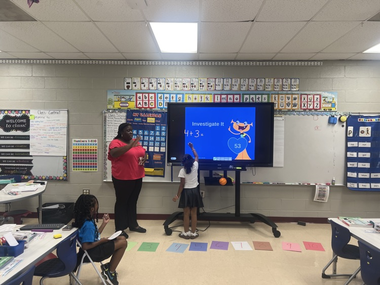 student solving problem on smart board