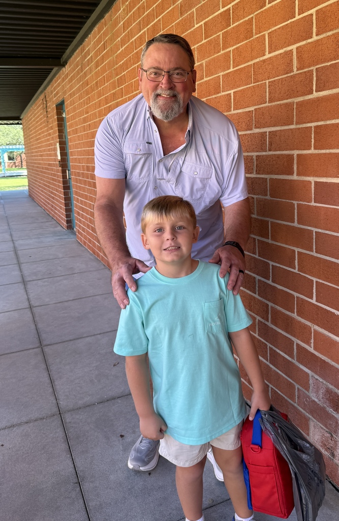 student with grandfather on sidewalk
