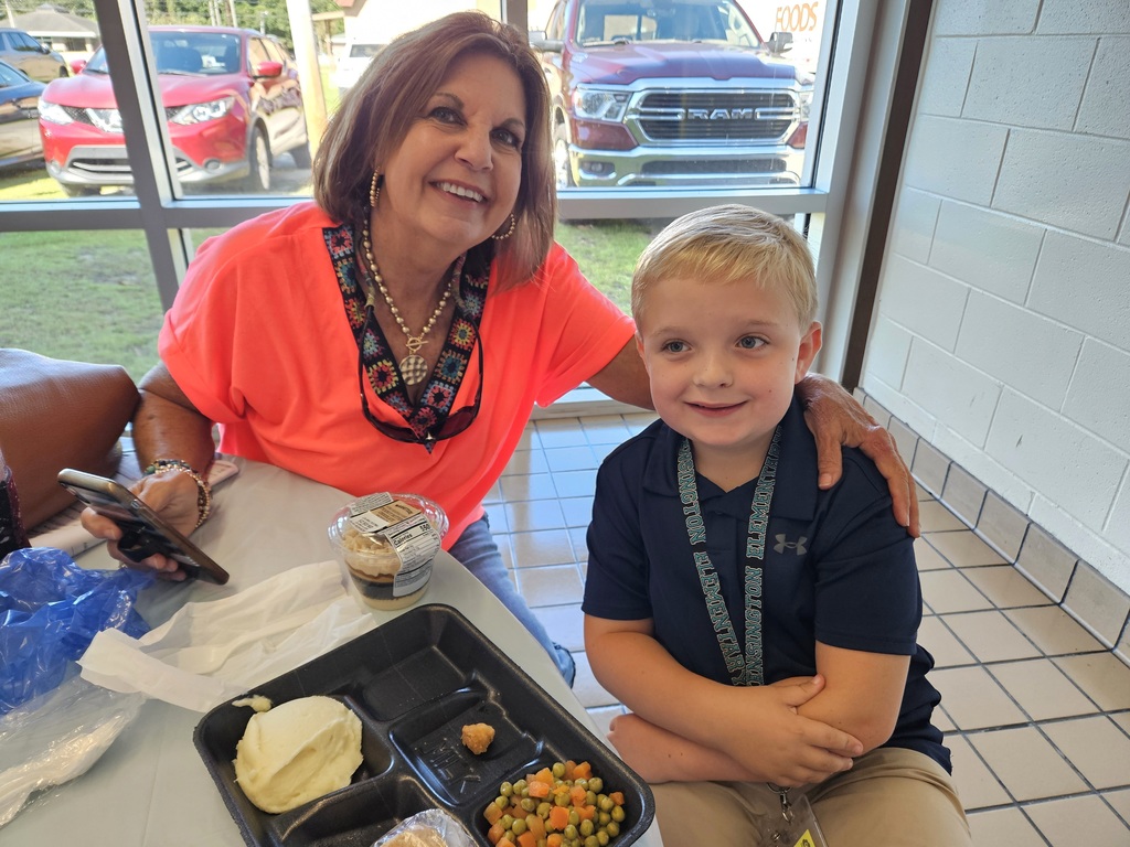 Grandparent with grandson in cafeteria
