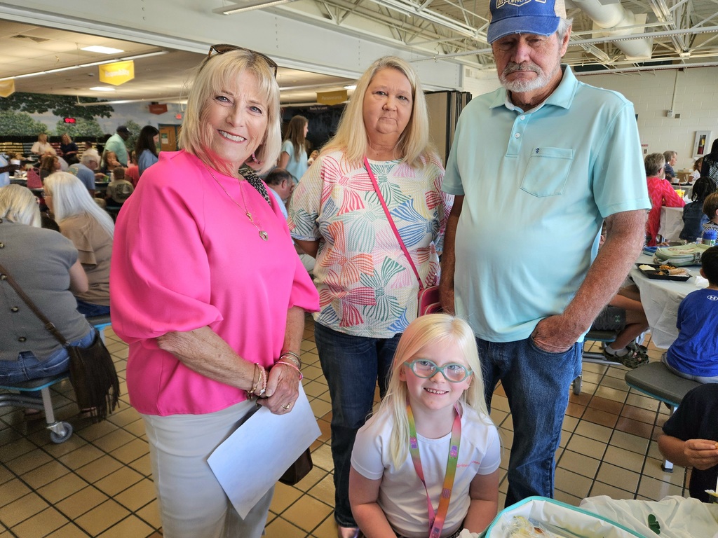 grandparents with granddaughter in cafeteria
