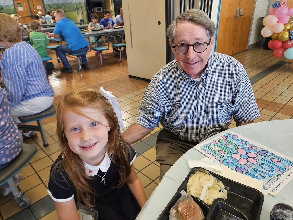 Grandfather with granddaughter in cafeteria