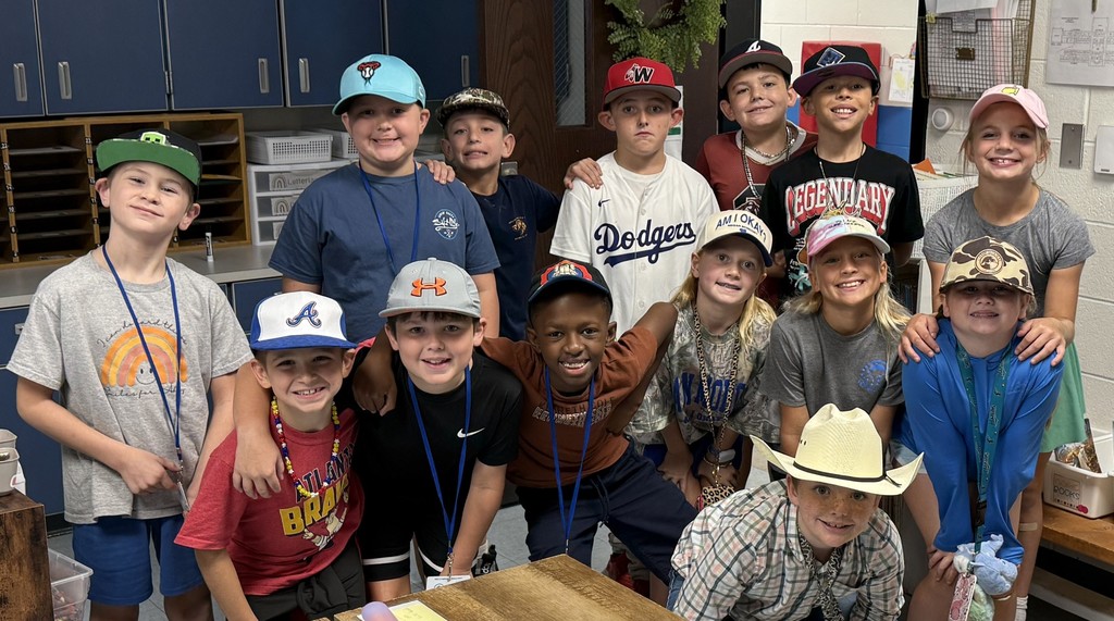 Students huddled together in a classroom.