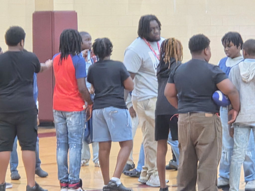 Hello Bear Family! These are pictures of our boys and girls playing in a game of flag football in our gym, hosted by Student Council. In the first picture, Mr. Williams is standing with several children explaining the rules of the game. In the other pictures, the children  are running up and down the courts playing football.