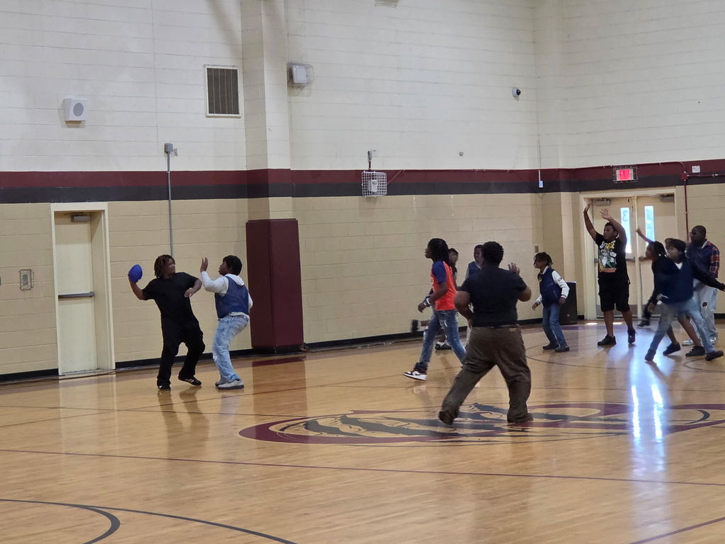 Hello Bear Family! These are pictures of our boys and girls playing in a game of flag football in our gym, hosted by Student Council. In the first picture, Mr. Williams is standing with several children explaining the rules of the game. In the other pictures, the children  are running up and down the courts playing football.