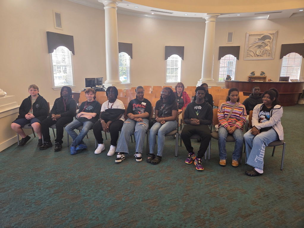 Kids sitting inside Coastal University.