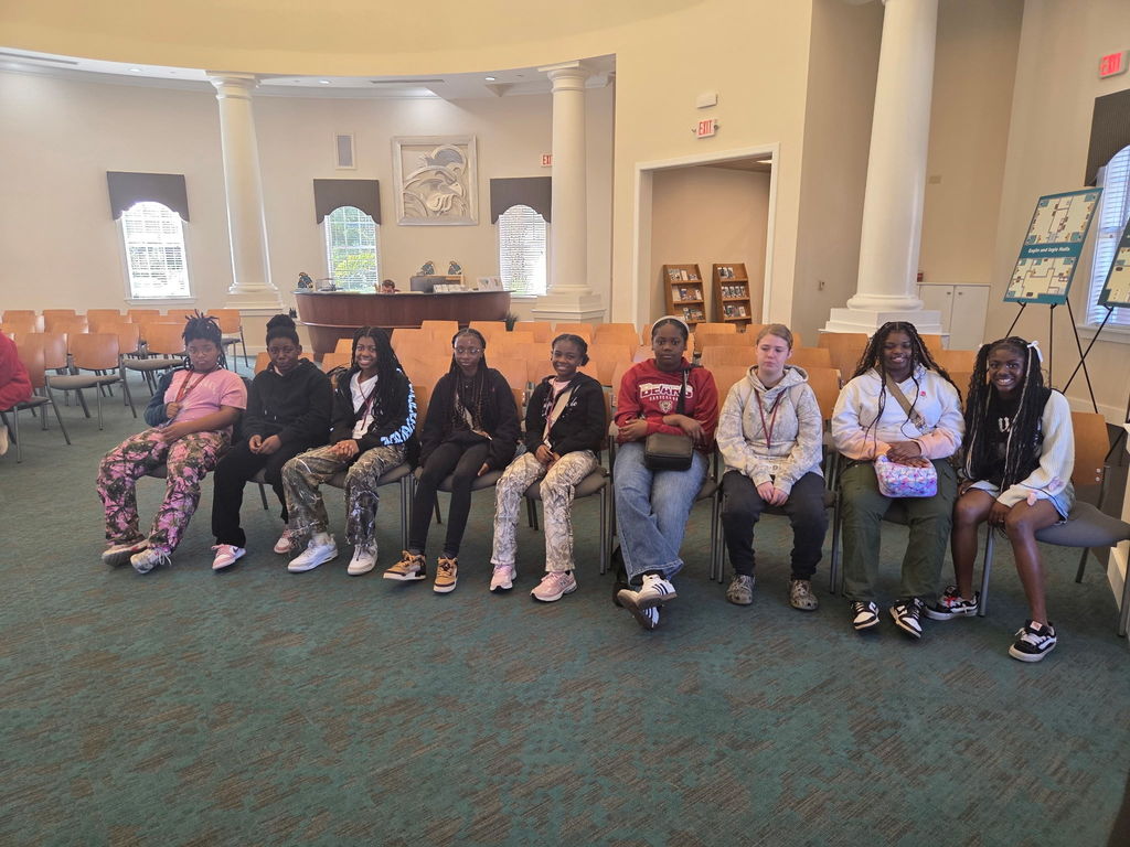 Kids sitting inside Coastal Carolina.