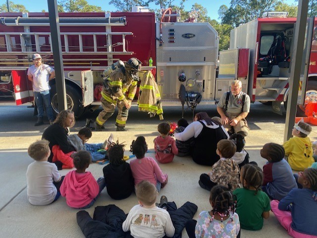 firefighters showing student their equipment