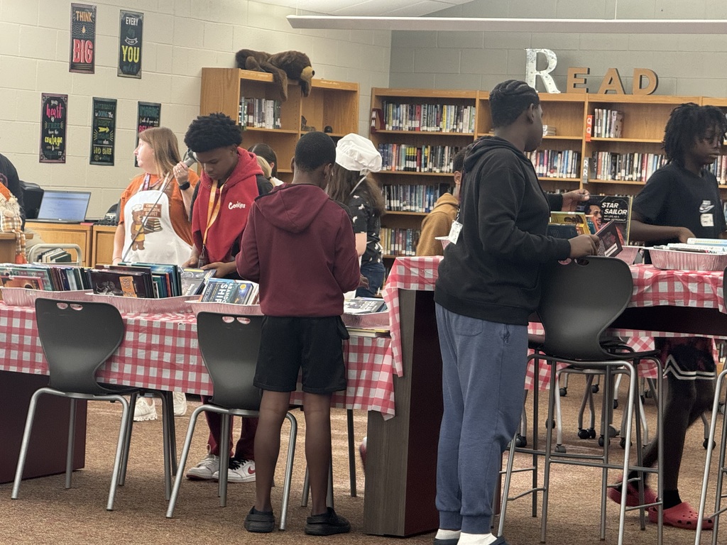 Students looking through books.