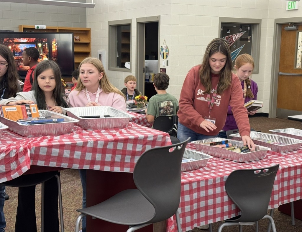 Girls looking at books.