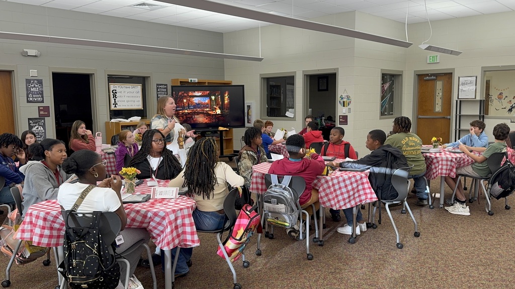 Mrs. Smith explaining the book tasting to the 6th grade class.