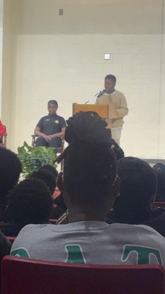 Student in beige clothes introducing his Dad  as the Speaker for the event.
