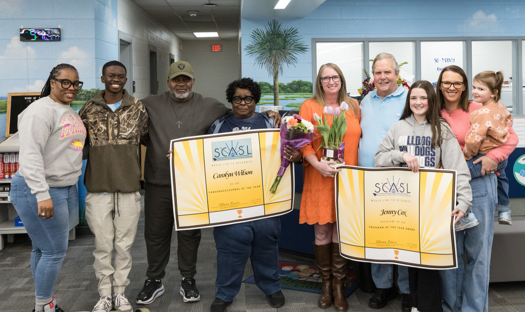 Wilson (center left) and Cox (center right) with their families.  