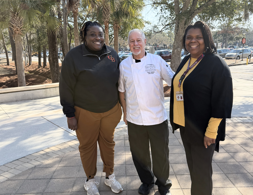 Ms. Fulton and  Mrs. Tucker standing with Chef Carmel.