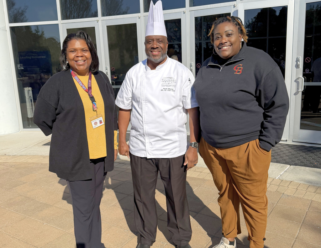 Ms. Fulton and  Mrs. Tucker  standing with Chef Kevin Mitchell.