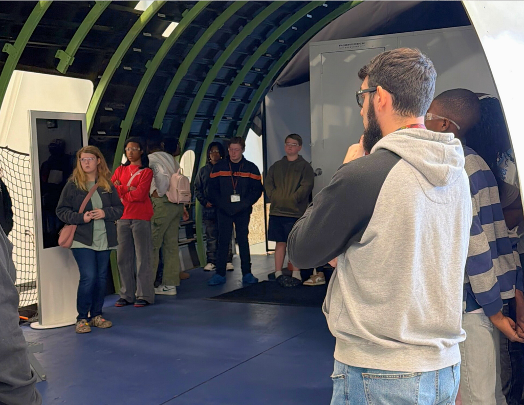 Our students and  teacher getting a first-hand look at a  representation  of an airplane hangar.