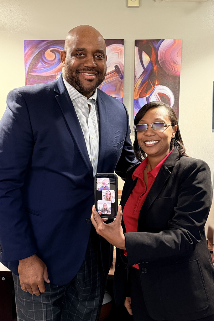 Waccamaw High School - Brittany Hilburn ( center on cell phone) pictured with school and District administration