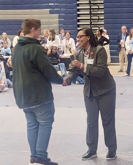 Student accepting trophy