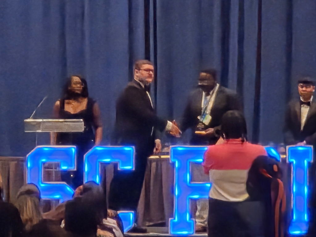 Khimir Giles being awarded for placing 4th