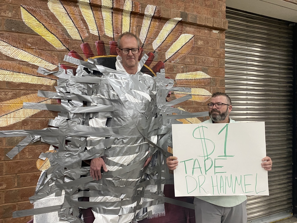 Dr. Hammel Duct taped to the wall