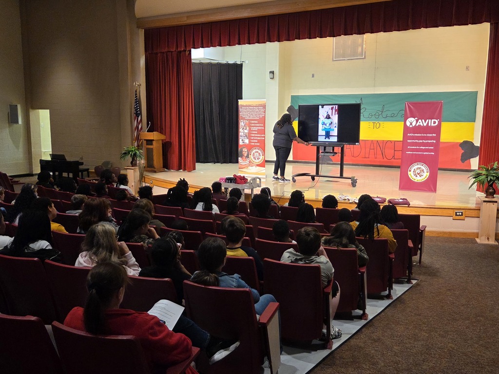 Mrs. Tucker speaking to 5th graders in the Auditorium.