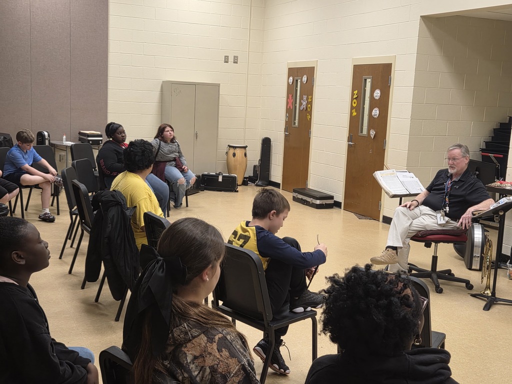 5th graders visiting Band teacher in the Band Room.