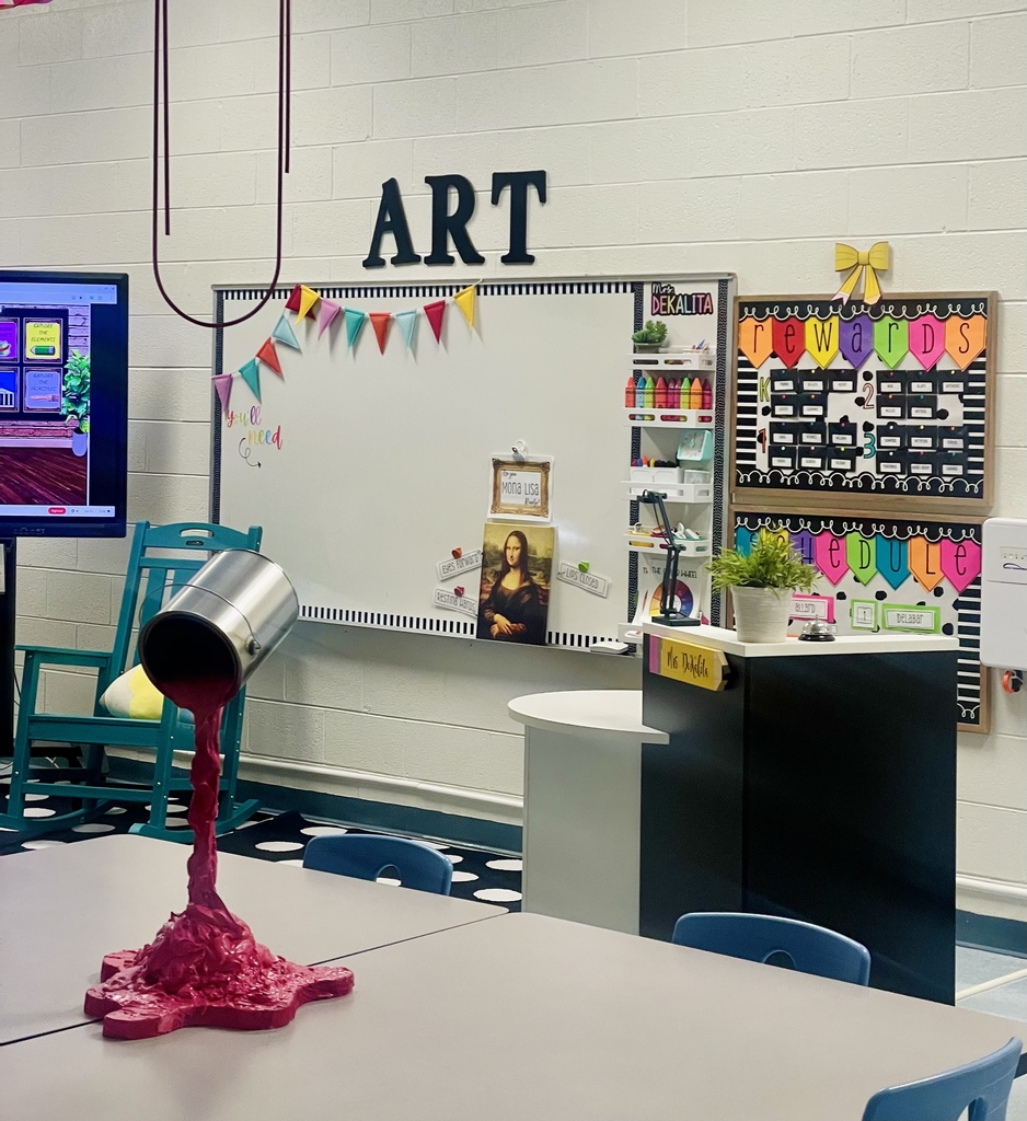 Colorful art classroom with a creative paint-pour display.