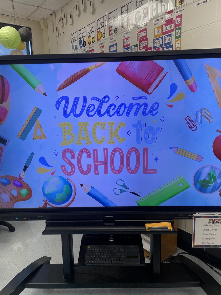 Classroom screen displaying a colorful welcome-back message.