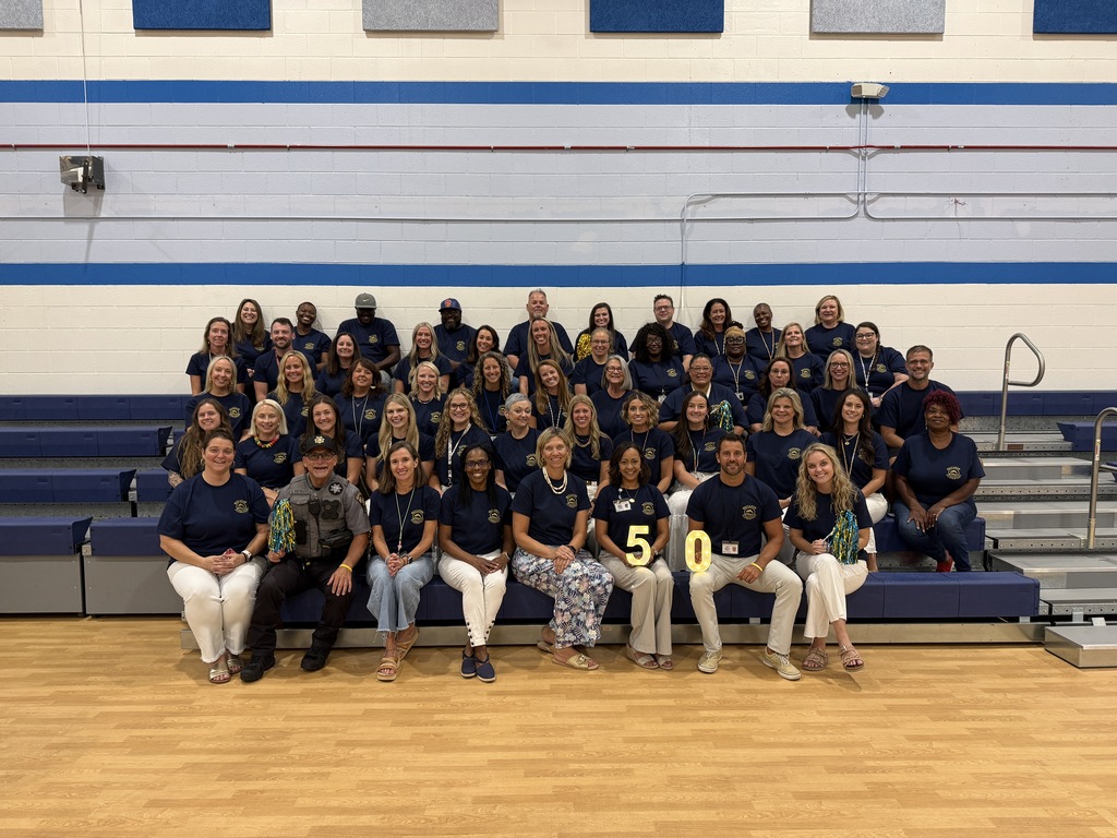 WES staff gathered in the gym for a Golden Year group photo.