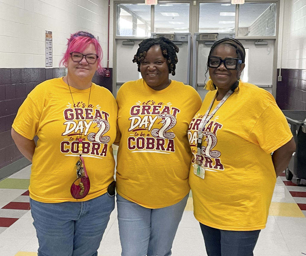 RMS teachers pose wearing Great Day shirts
