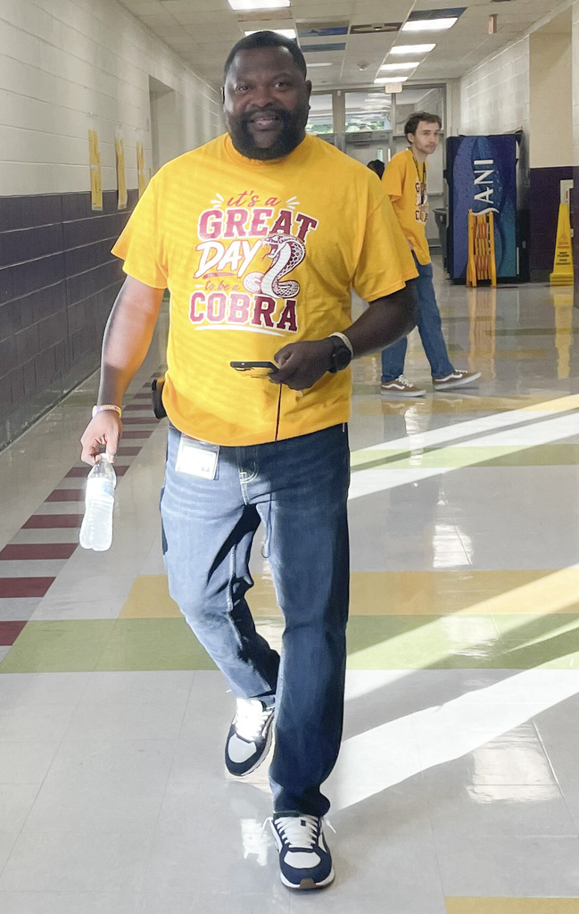 RMS teachers pose wearing Great Day shirts