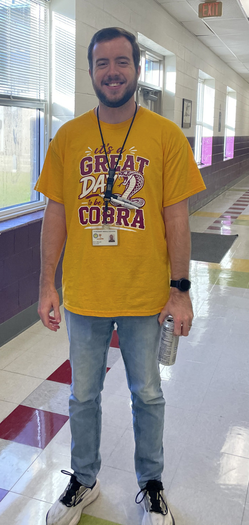 RMS teachers pose wearing Great Day shirts