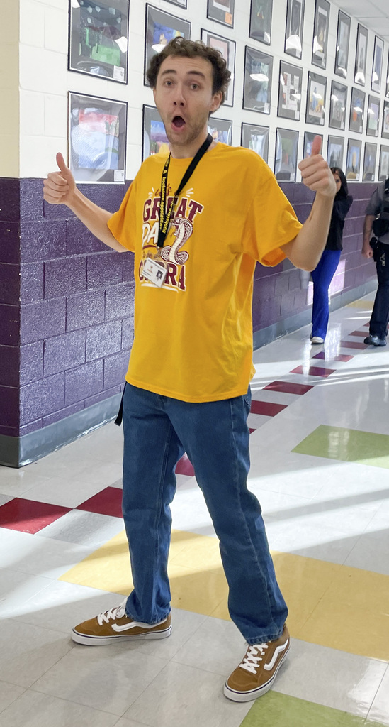 RMS teachers pose wearing Great Day shirts
