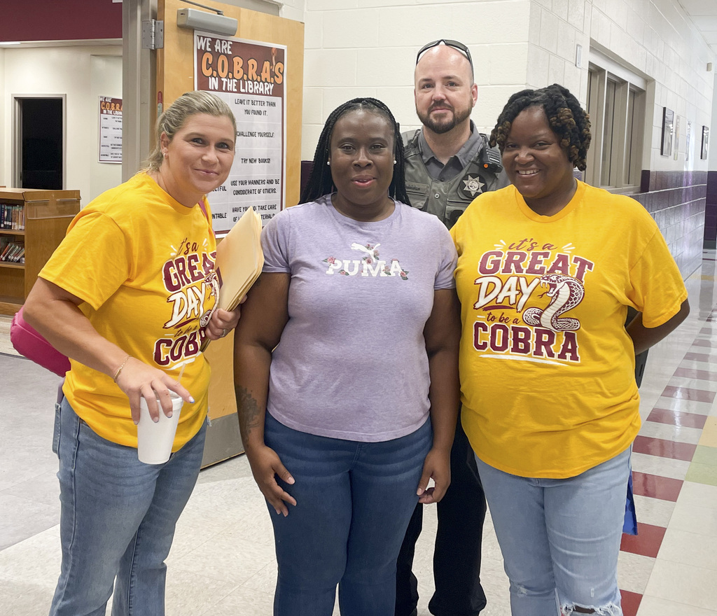 RMS teachers pose wearing Great Day shirts