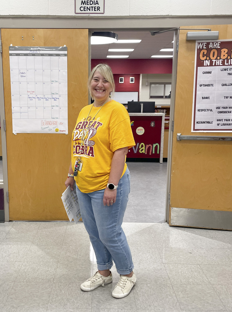 RMS teachers pose wearing Great Day shirts