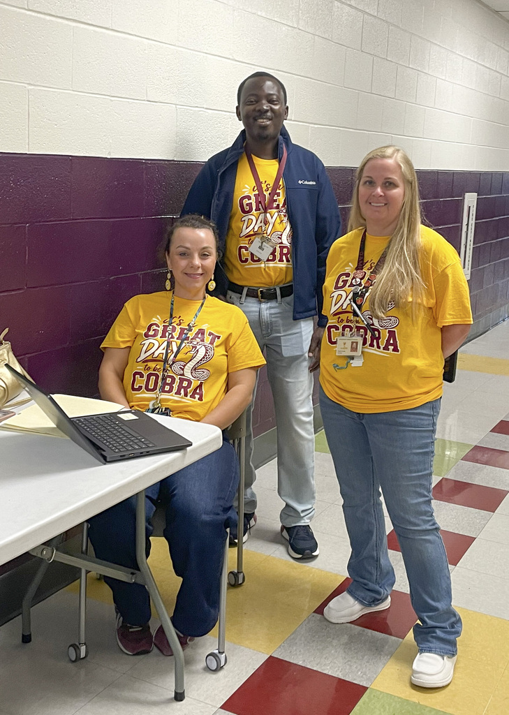 RMS teachers pose wearing Great Day shirts