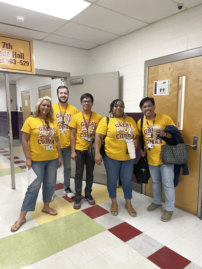 RMS teachers pose wearing Great Day shirts