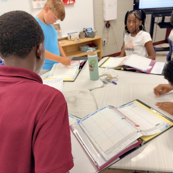 Fifth graders at BFESCPA setting up Binders