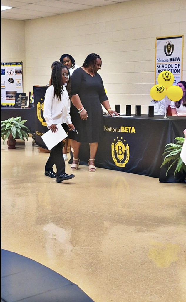 Principal Frasier and student being inducted into Beta