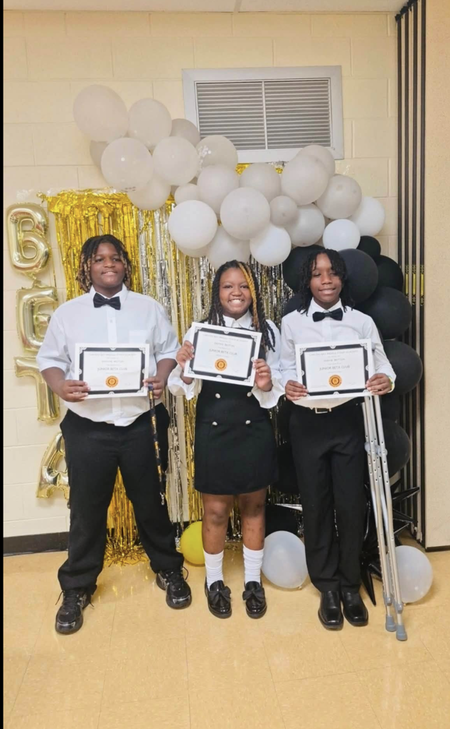 Students proudly showing certificates after Beta Club Induction