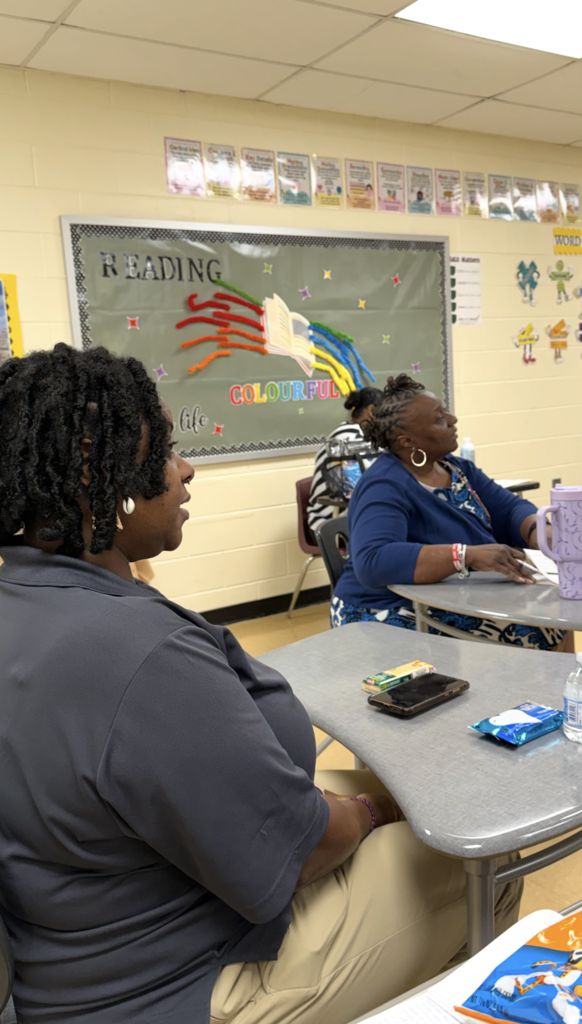 Principal Fraiser and staff listening to Ms. Mulligan.