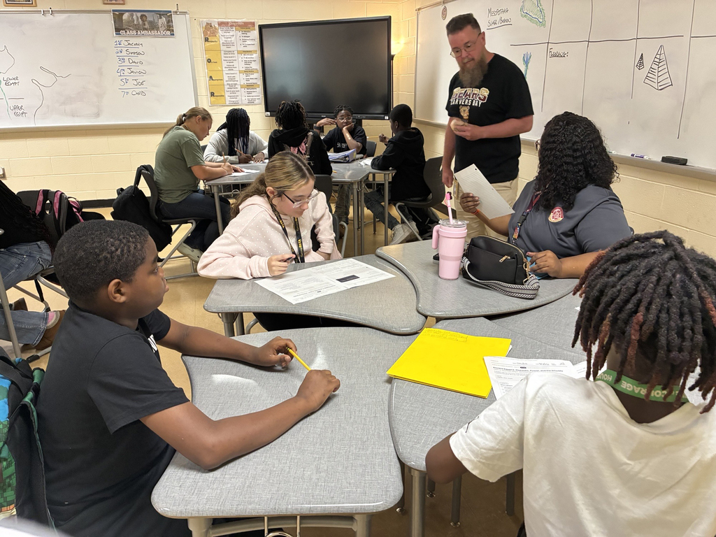 Students learning in groups in a classroom at Carvers Bay Middle STEAM Academy.