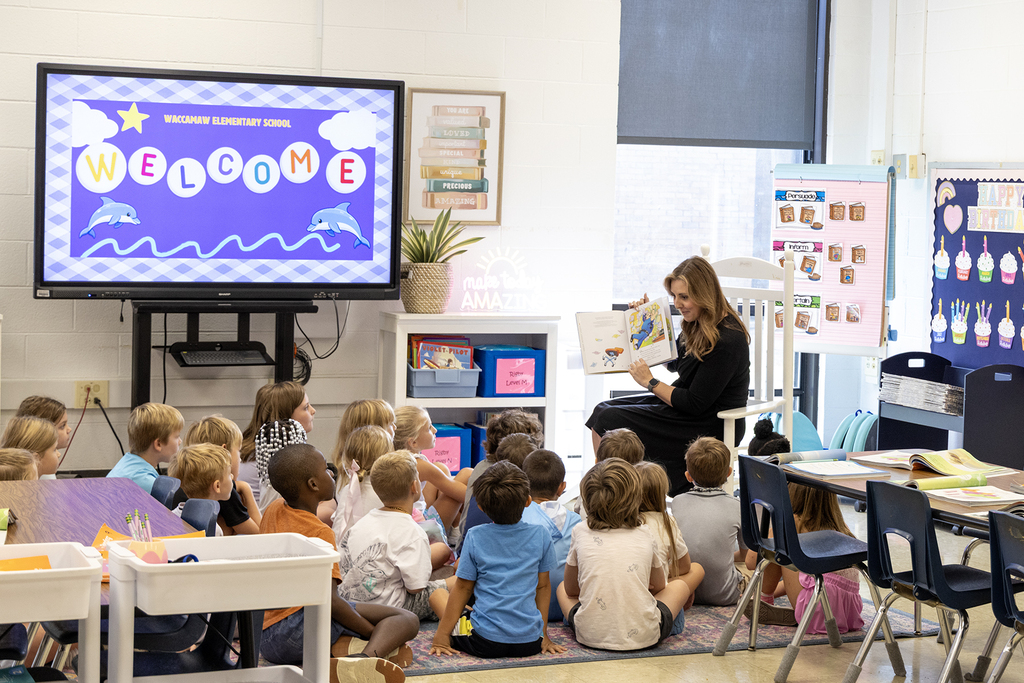 State Superintendent Ellen Weaver reads to students at Waccamaw Elementary.