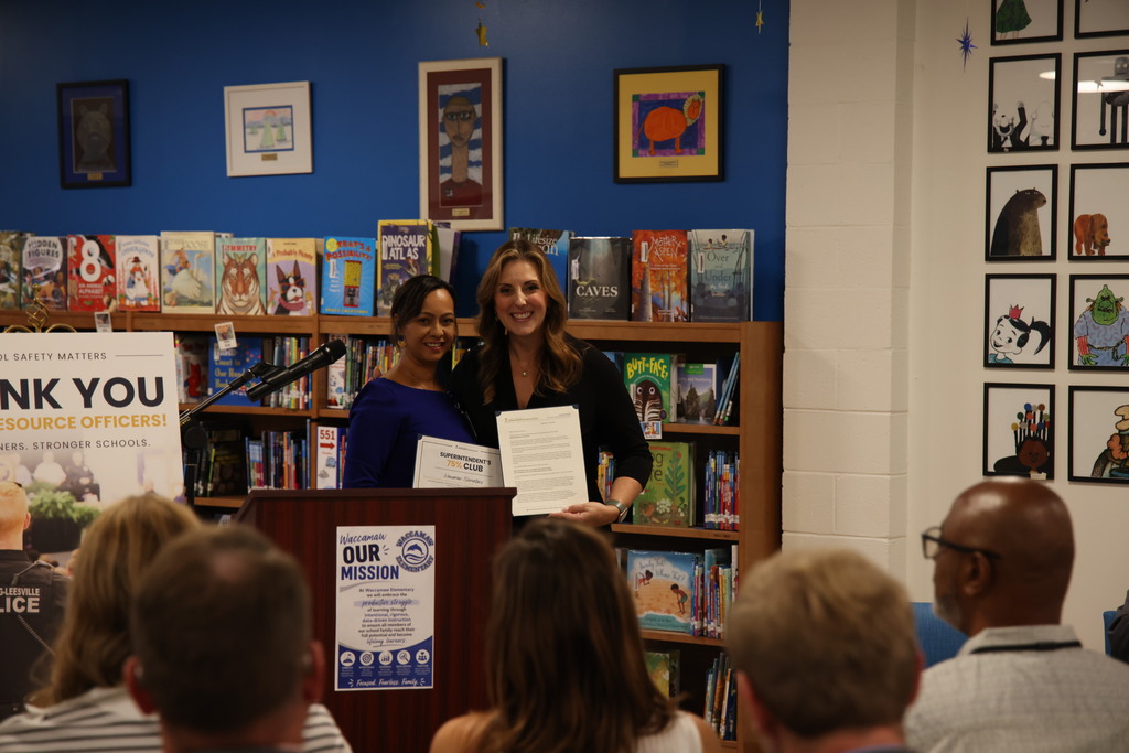 Superintendent Ellen Weaver presents WES Principal Ashley Cameron a "75% Club" certificate.