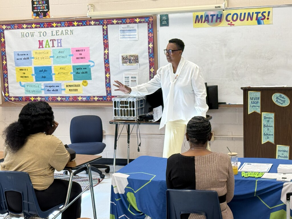 Students seated at desks in a classroom engaging in the SC Works presentation.